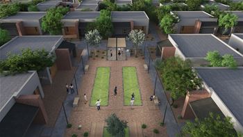 An aerial view of a courtyard with people playing tennis